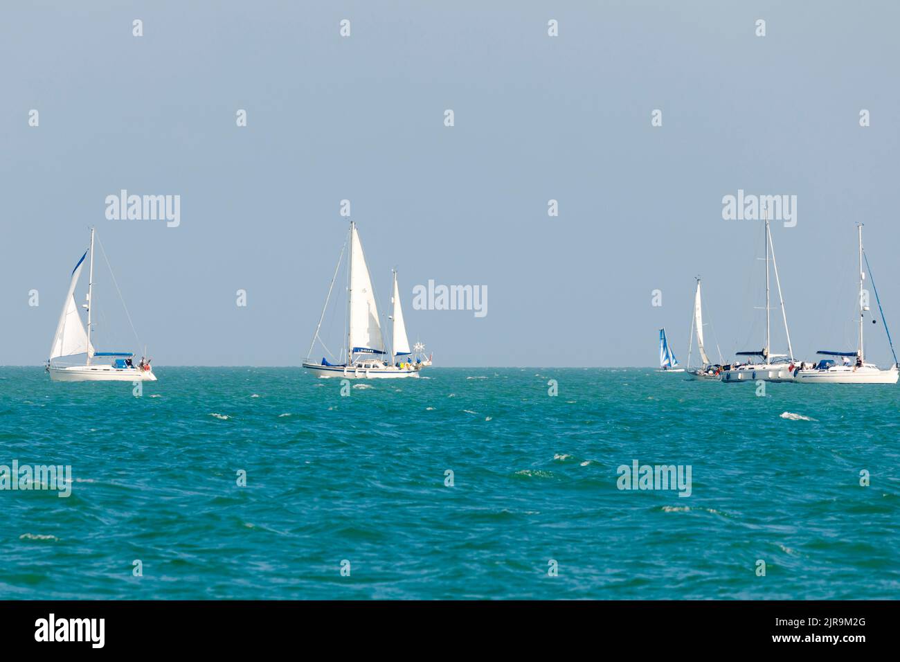 Yachts sailing on the English channel on a sunny summers day. East Sussex, UK Stock Photo