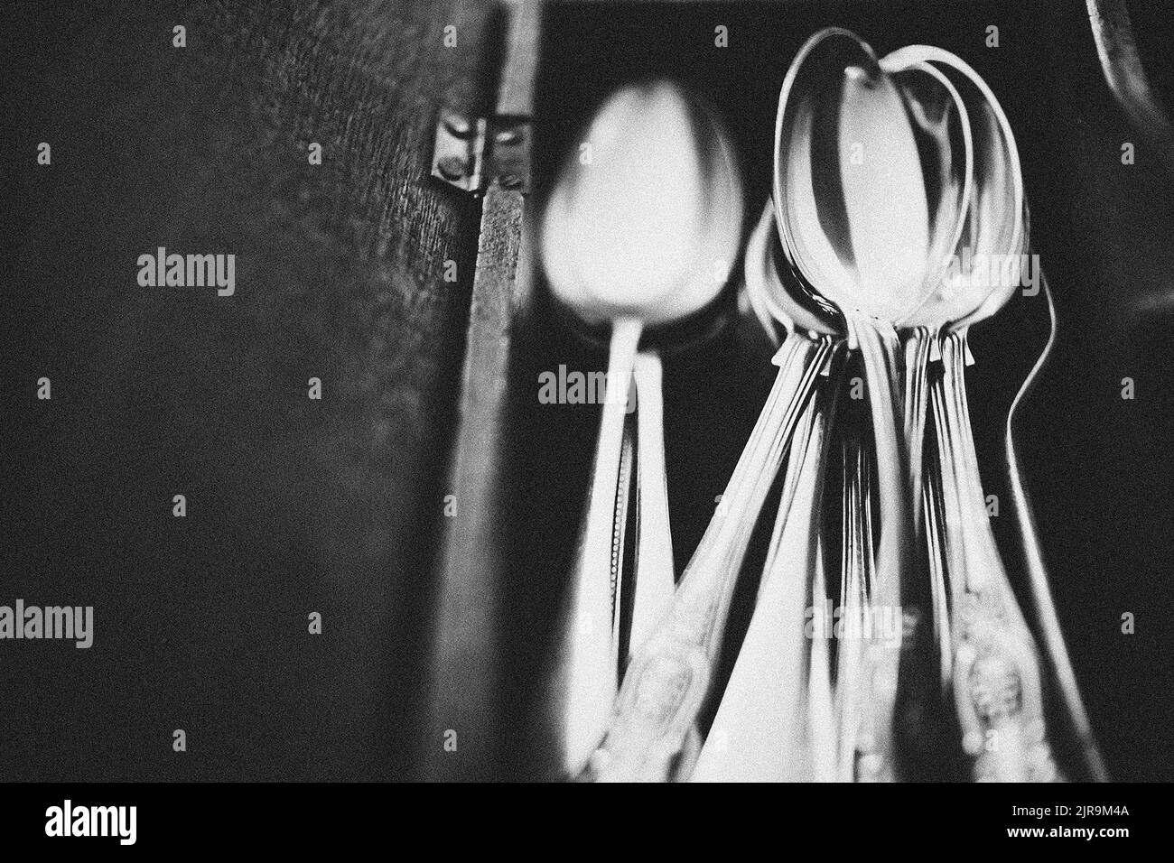 Vintage cutlery in vintage wooden box. Selective focus on spoons, close up Stock Photo