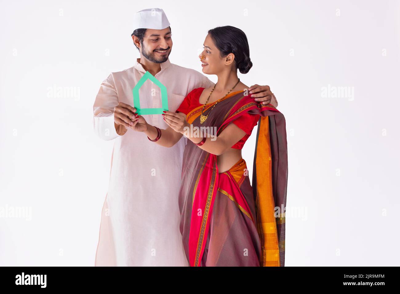 Portrait of Maharashtrian couple holding their new dream home in hands Stock Photo