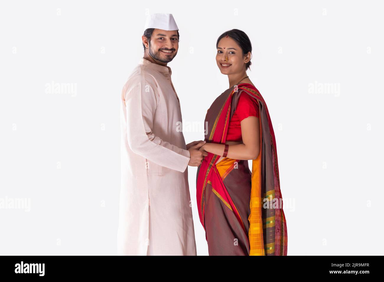Portrait of Maharashtrian couple standing face to face with holding hands Stock Photo
