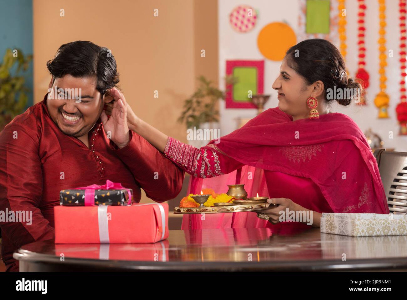Sister lovingly pulling her brother's ear on the occasion of Raksha