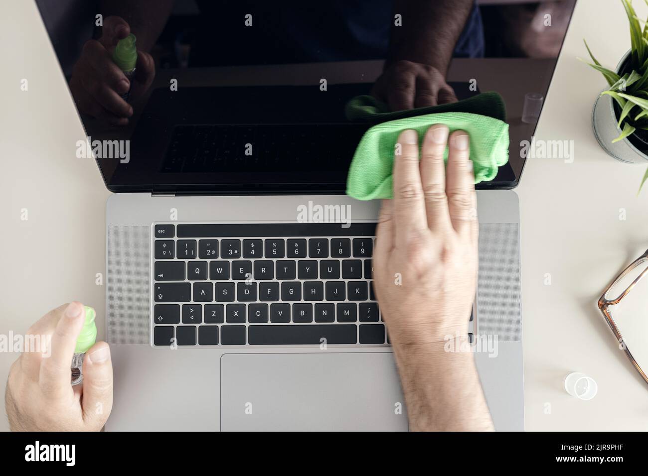 Computer cleaning concept. Top view of a male human hands cleaning a