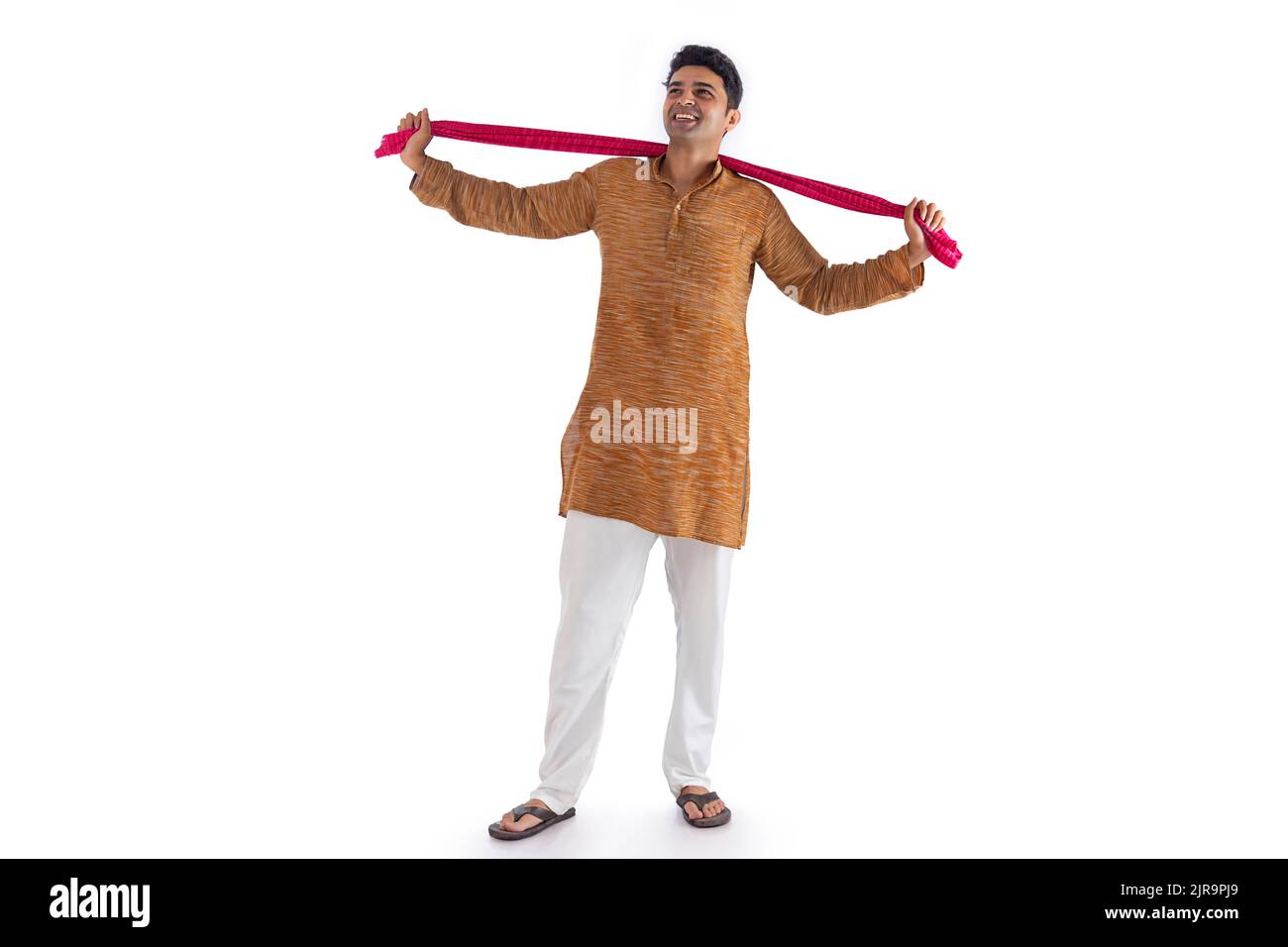 Portrait of a farmer standing with arms outstretched against white ...