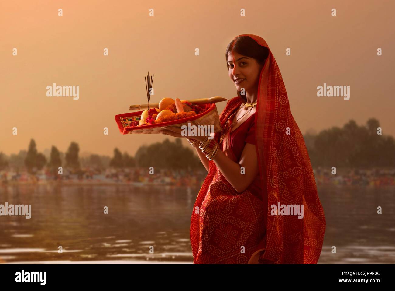 woman from Bihar offers prayers to the sun in the early morning hours ...