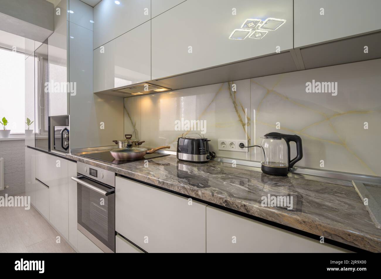 Interior of modern trendy white kitchen Stock Photo