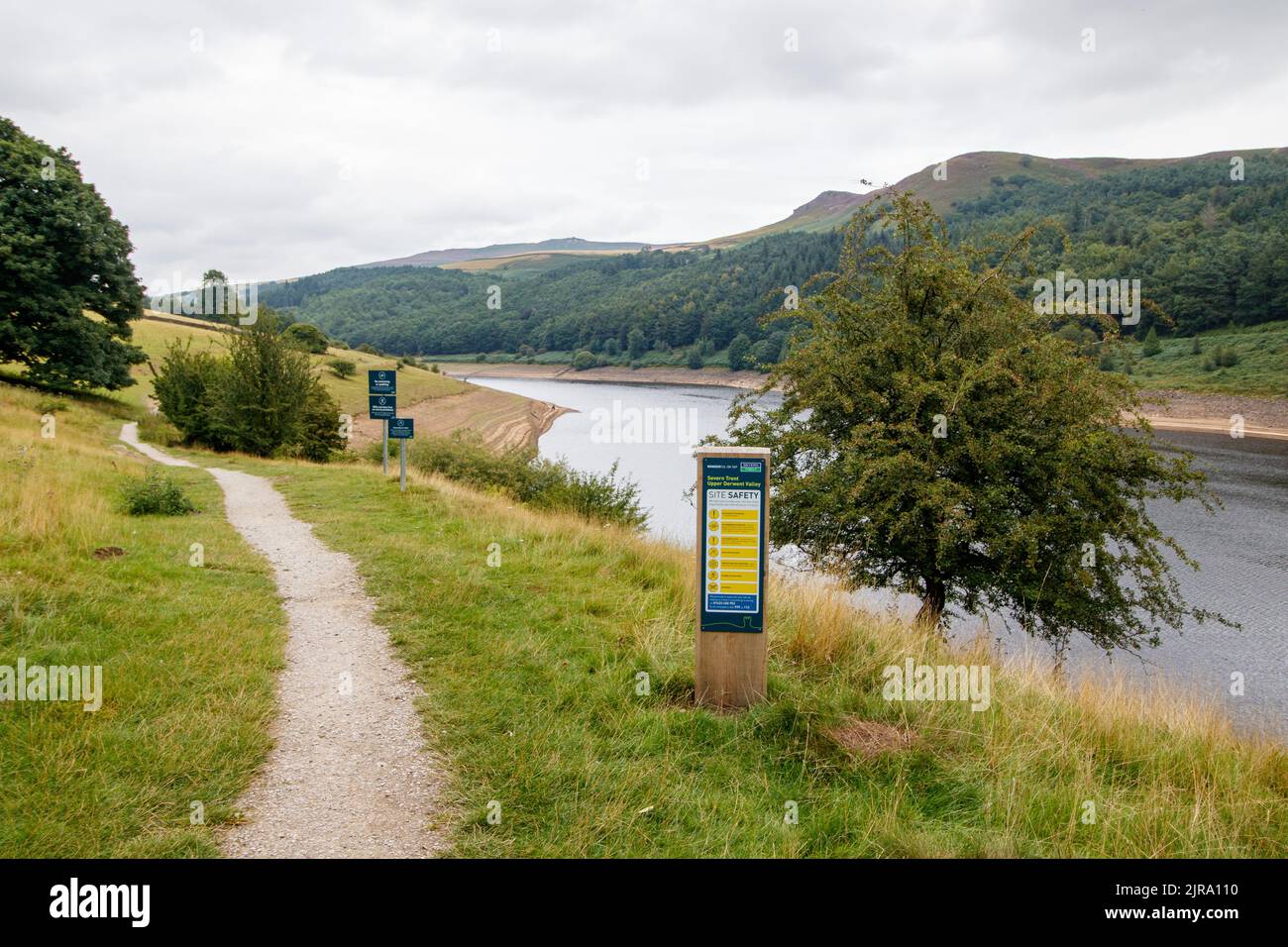 The view across the Ladybower reservoir near the Ashopton Bridge on the A57 that crosses over the ladybower dam in the peak district.The Ladybower reservoir during the dry and drought weather in the summer of 2022. Ladybower Reservoir is a large Y-shaped, artificial reservoir, the lowest of three in the Upper Derwent Valley in Derbyshire, England.The Ladybower reservoir during the dry and drought weather in the summer of 2022. Ladybower Reservoir is a large Y-shaped, artificial reservoir, the lowest of three in the Upper Derwent Valley in Derbyshire, England. Stock Photo