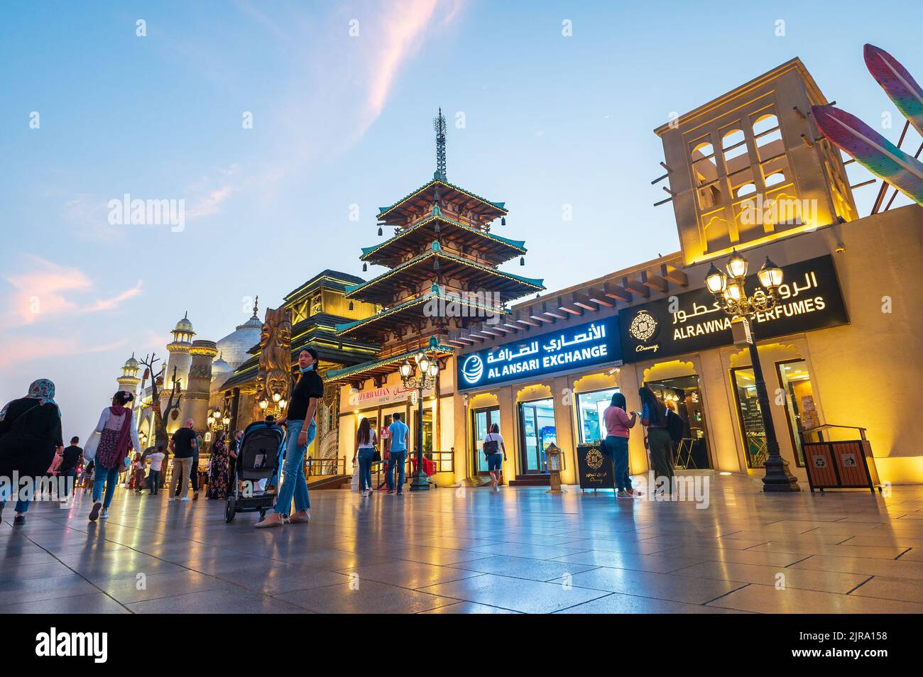 Dubai, United Arab Emirates - April 4, 2022: Crowded Global village in Dubai at sunset. Popular tourist attraction with shops and restaurants from aro Stock Photo