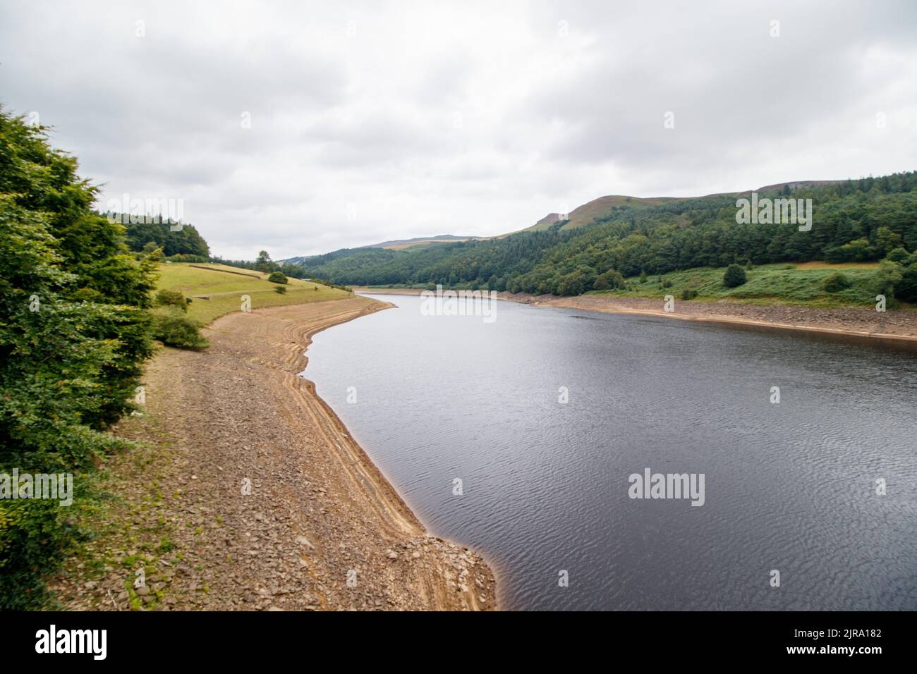 The Ladybower reservoir during the dry and drought weather in the summer of 2022. Ladybower Reservoir is a large Y-shaped, artificial reservoir, the lowest of three in the Upper Derwent Valley in Derbyshire, England. Stock Photo