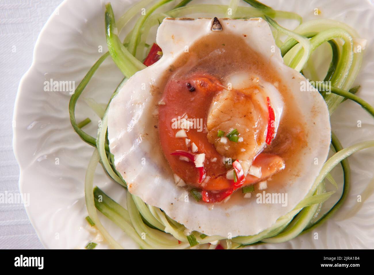 Scallops in sweet chilli sauce on bed of cucmber Stock Photo Alamy