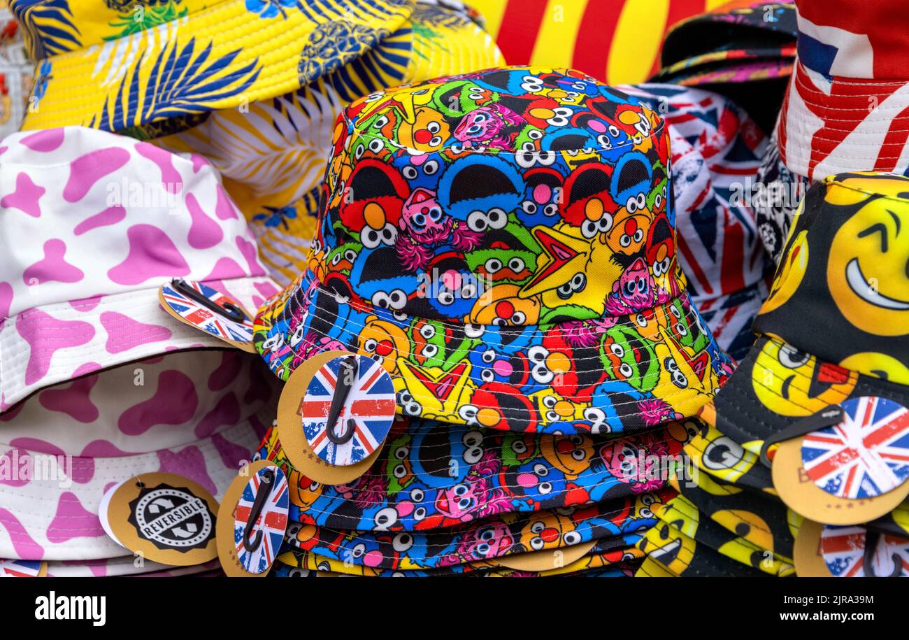 Colourful display of hats with emojis and Union Jack badges on sale, UK Stock Photo