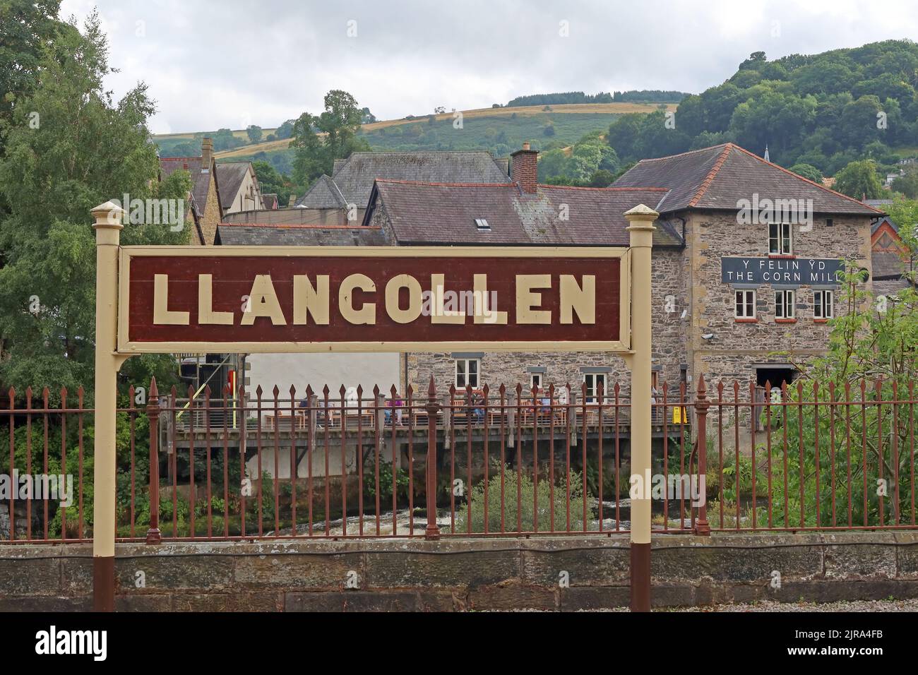 Llangollen heritage railway station sign on platform, with river Dee in background, Denbighshire, North Wales, UK Stock Photo