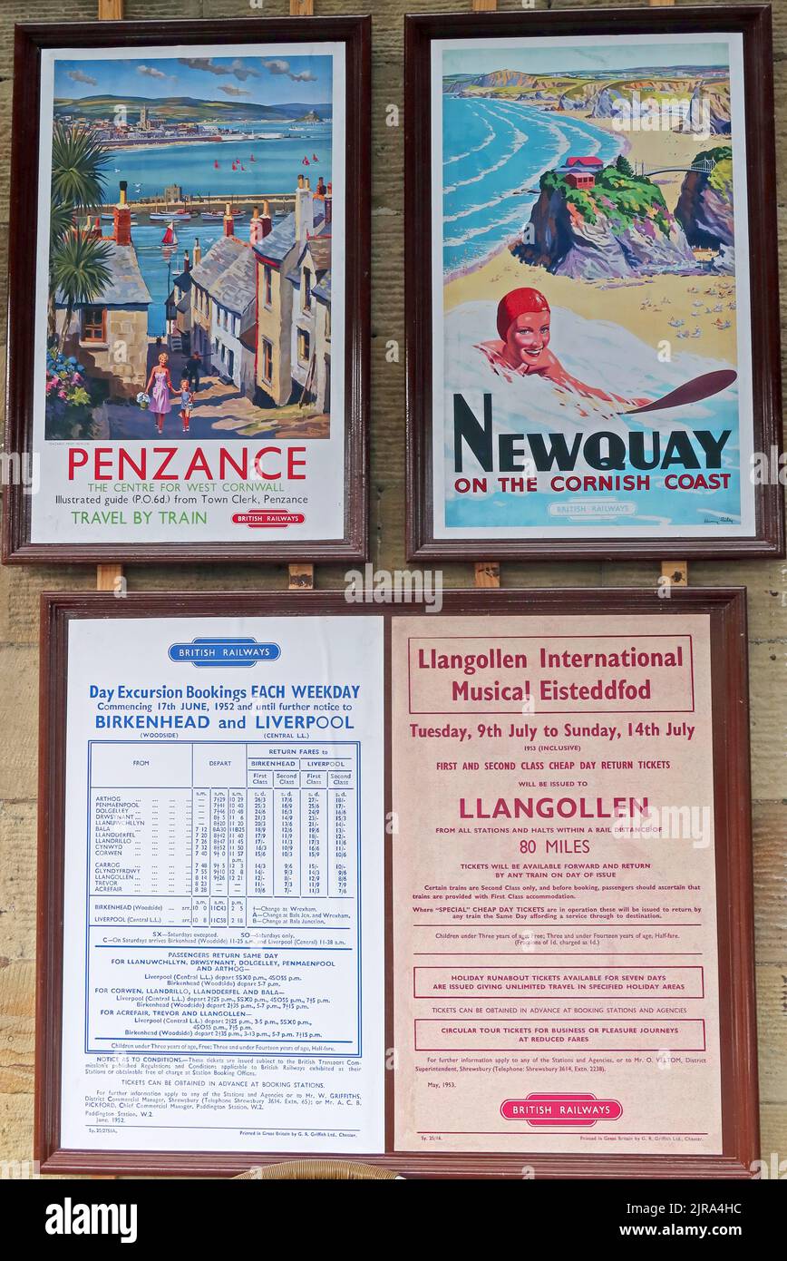 Vintage BR Penzance and Newquay British Rail railway posters with excursion and Llangollen Eisteddfod notices in a preserved station display. Stock Photo