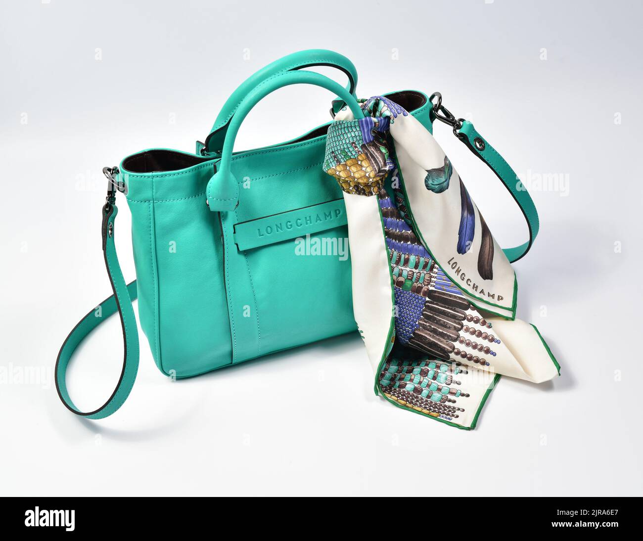 Green leather Longchamp purse and matching scarf Stock Photo