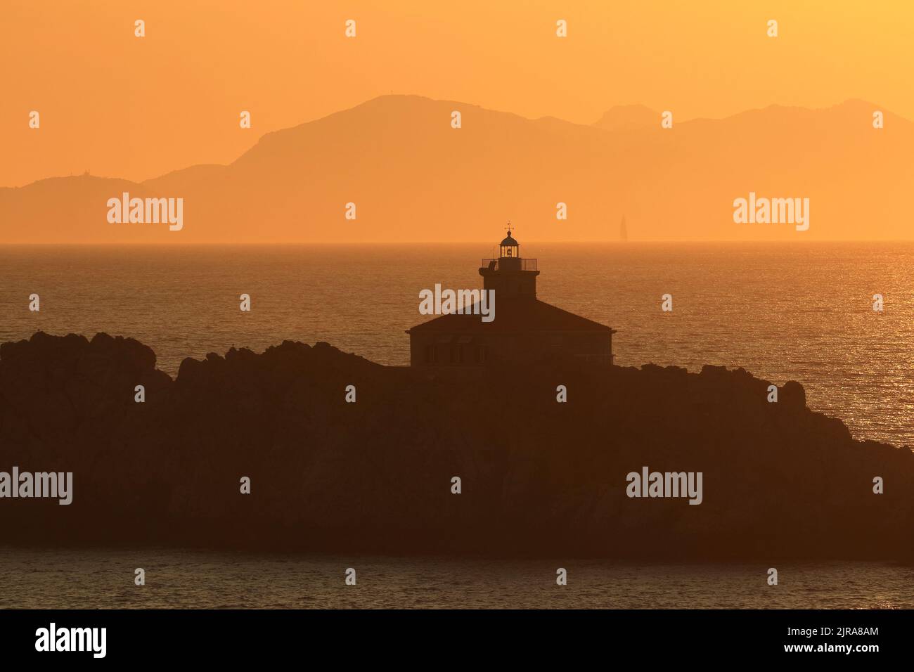 Sunset on Adriatic sea, Grebeni islands with lighthouse, near Dubrovnik touristic destination, warm summer colors Stock Photo