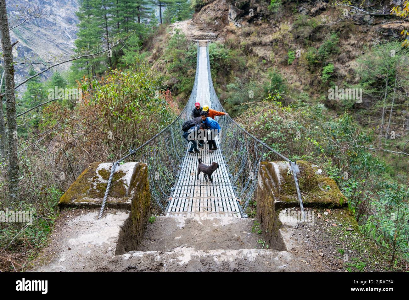 A closeup of people on a suspended bridge close to Namche Bazaar, Everest Base Camp, Nepal Stock Photo