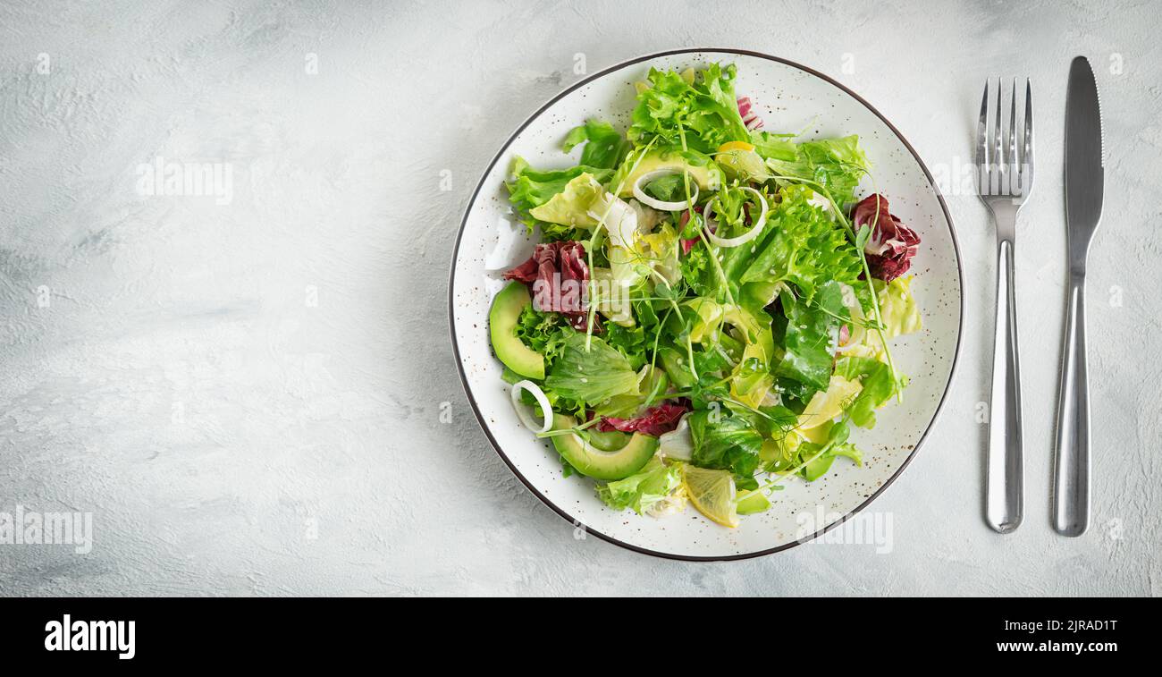 Green salad plate on gray background. Top view, copy space. Stock Photo