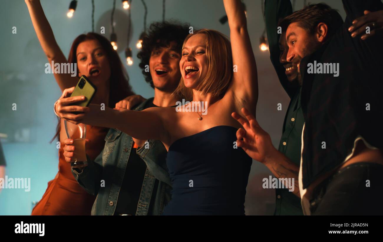 Group of happy multiethnic friends grimacing and gesturing while taking ...
