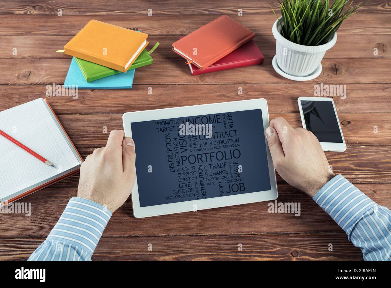 Businessman with a computer tablet at a work desk Stock Photo - Alamy