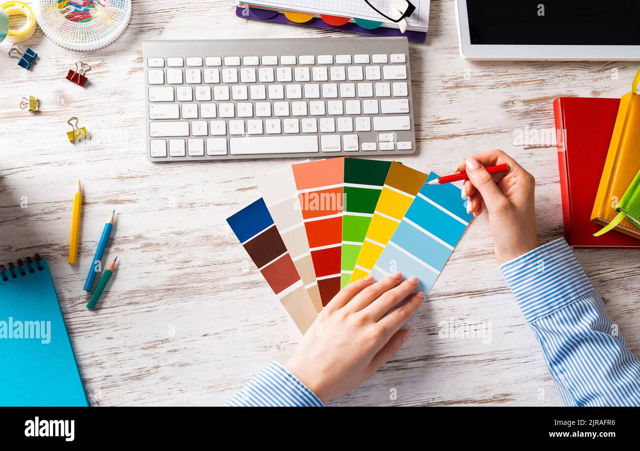 Interior designer choosing colors from swatches Stock Photo - Alamy