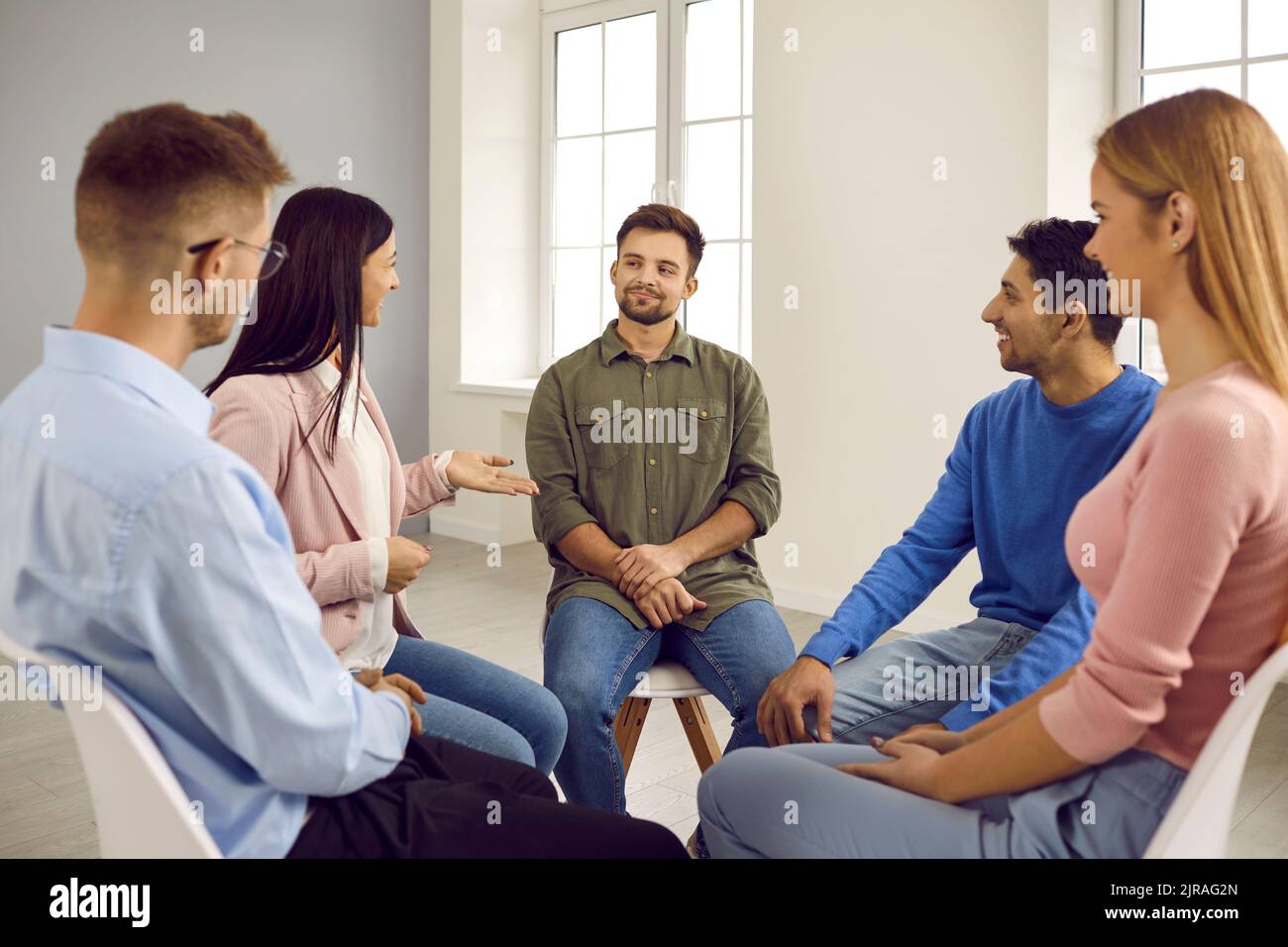 Diverse people sit in circle have counseling session Stock Photo
