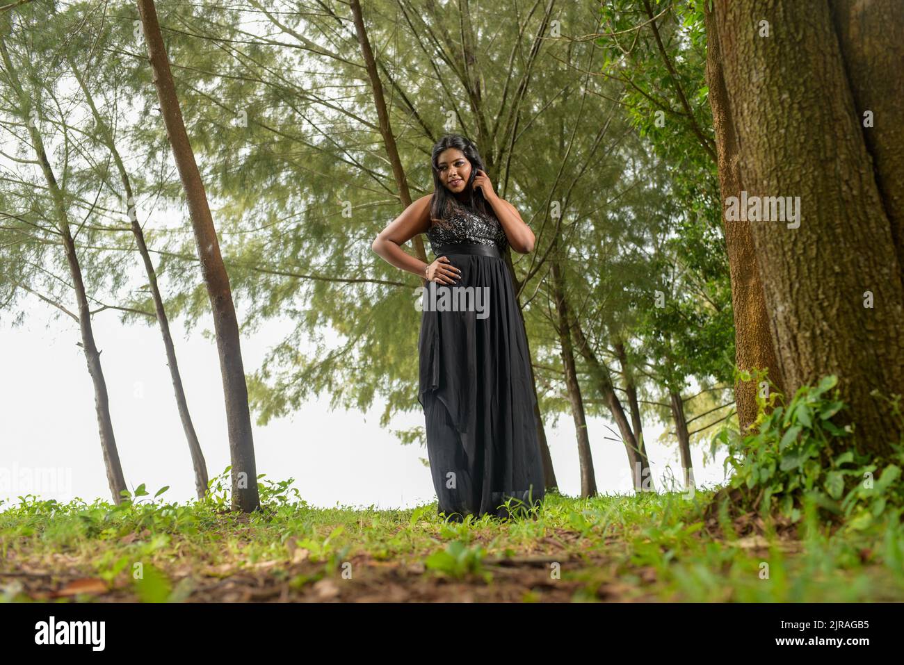 A woman with long elegant black dress hi-res stock photography and ...
