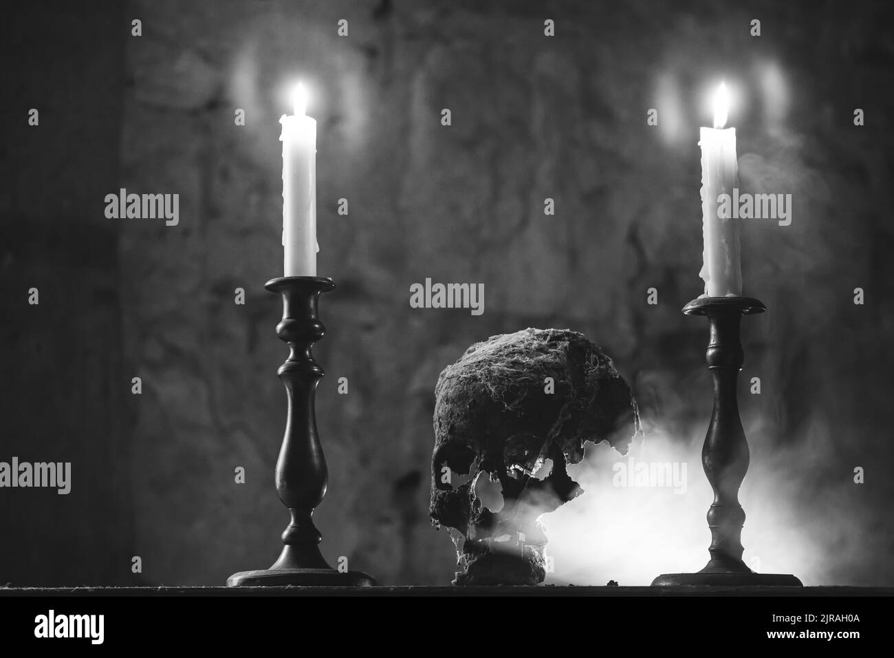 Real human skull with candles in the darkness spooky horror wallpaper