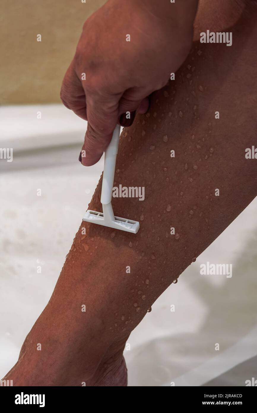 Female shaves legs hires stock photography and images Alamy