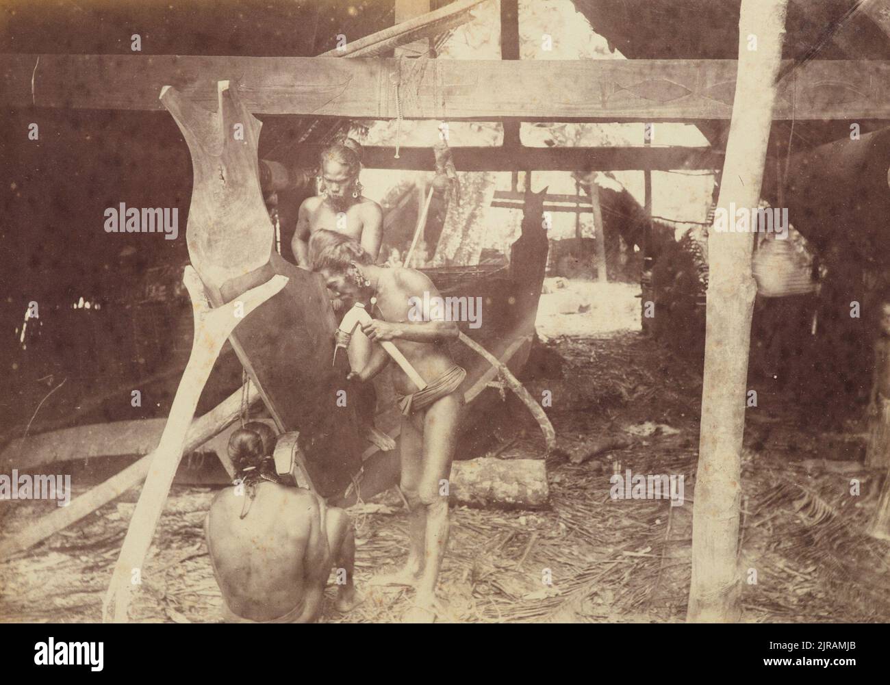 Canoe makers Lukunor. From the album: Views in the Pacific Islands, 1886, Caroline Islands, by Thomas Andrew. Stock Photo