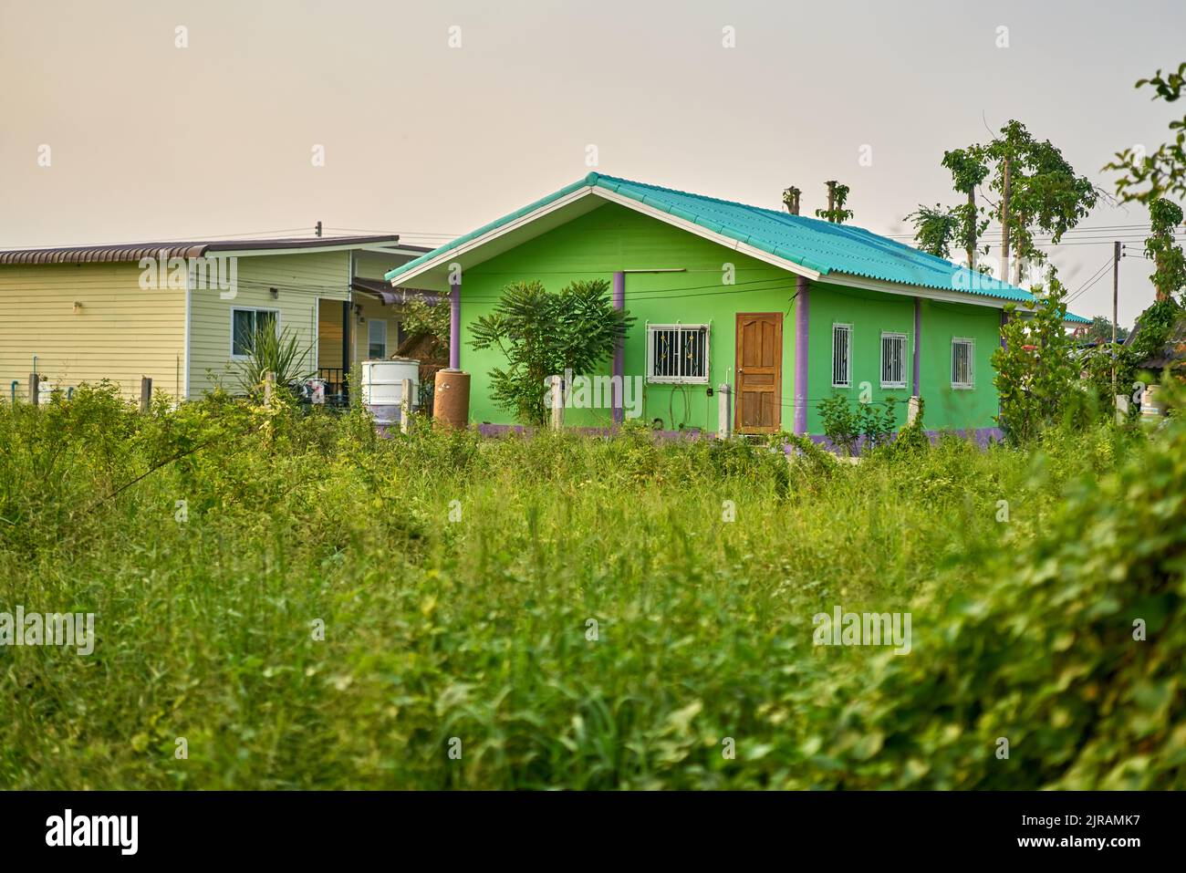 A small simple house in a green landscape. Stock Photo