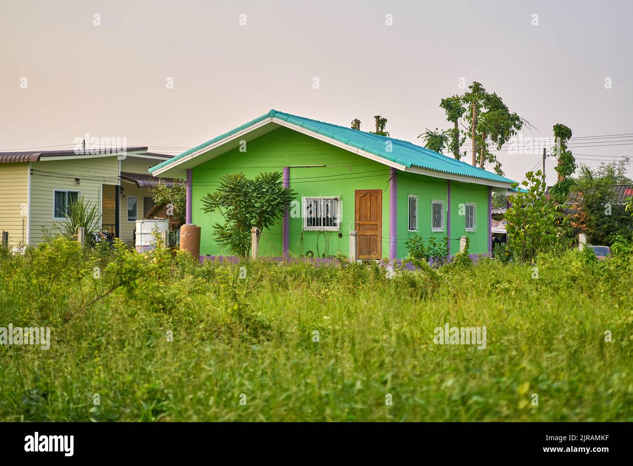 A small simple house in a green landscape. Stock Photo