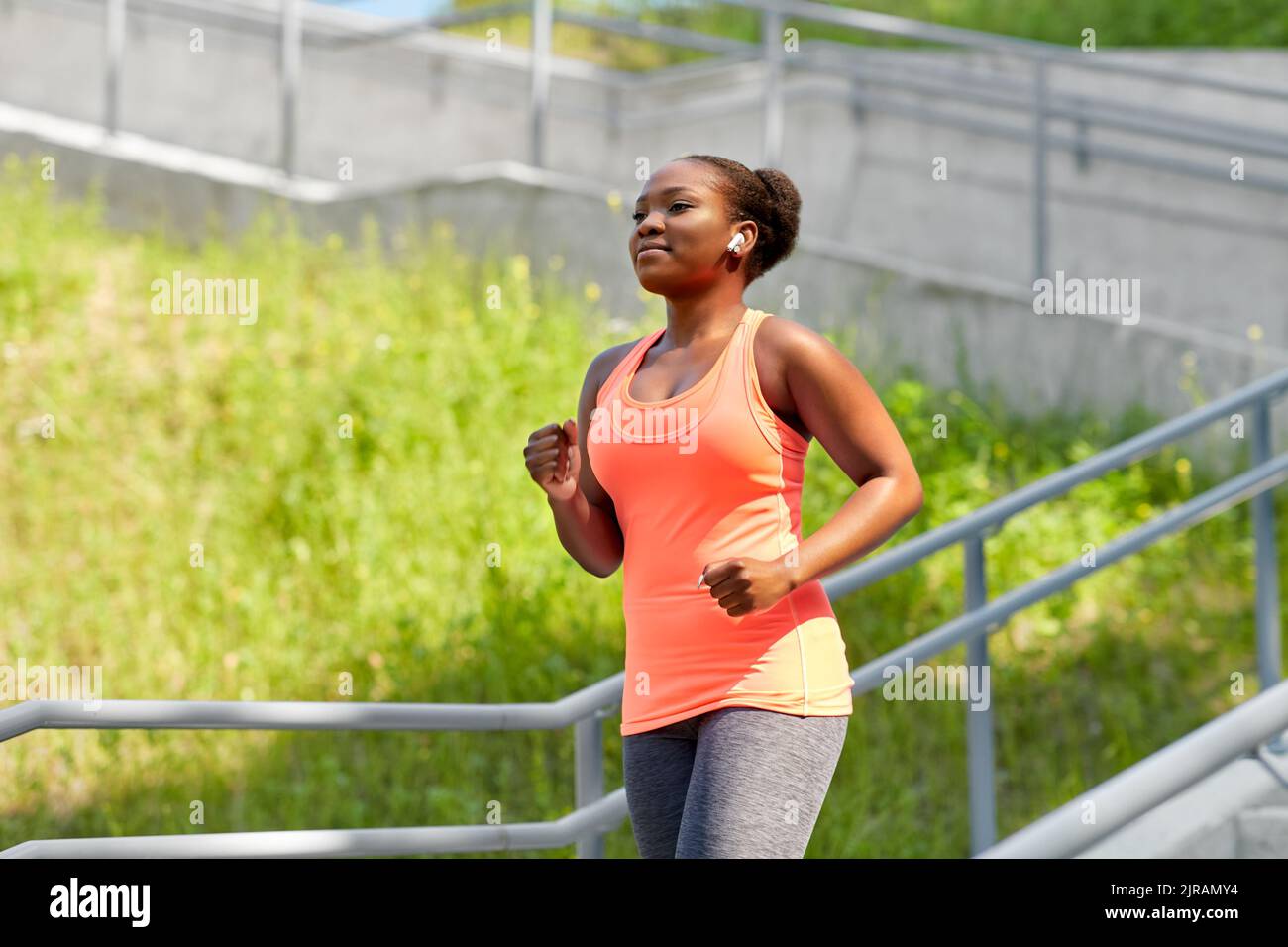 Black woman running up stairs hi-res stock photography and images - Alamy