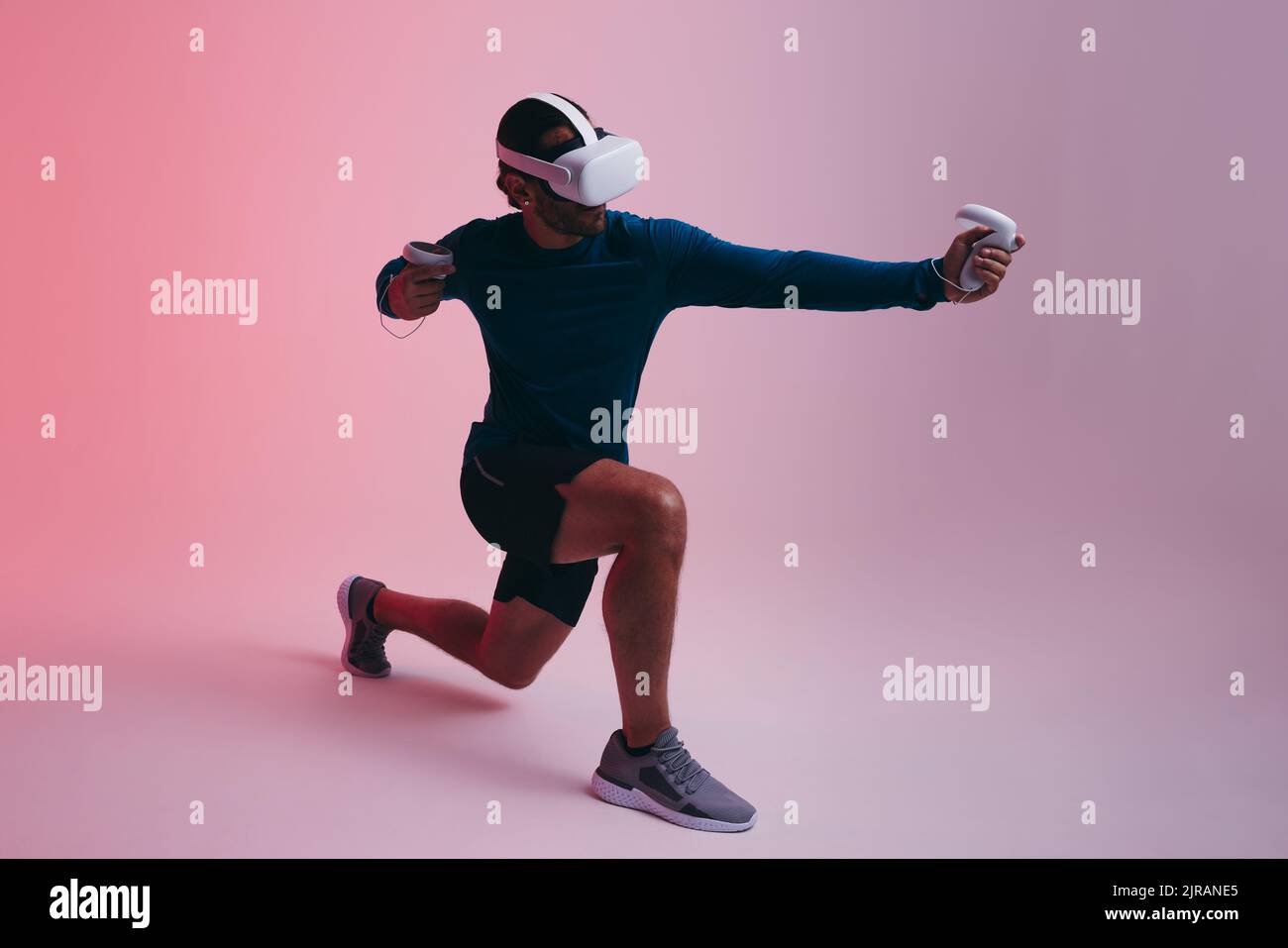 Sporty young man playing archery in virtual reality. Young man shooting