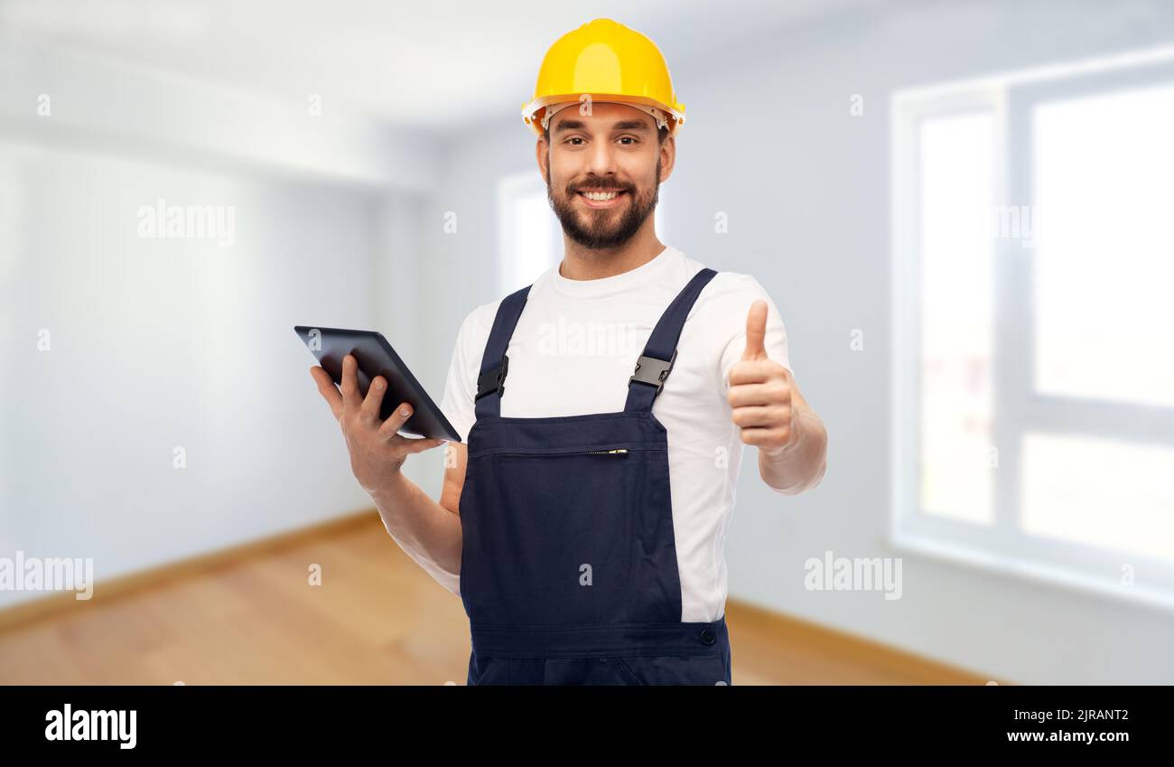 worker or builder with tablet pc showing thumbs up Stock Photo