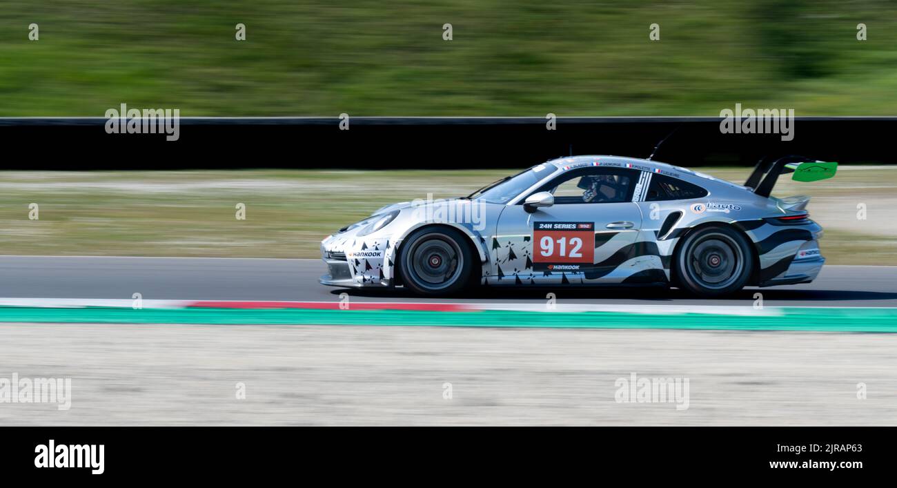 Porsche 911 gt race car action on racetrack blurred motion background. Mugello, Italy, march 25 2022. 24 Hours series Stock Photo