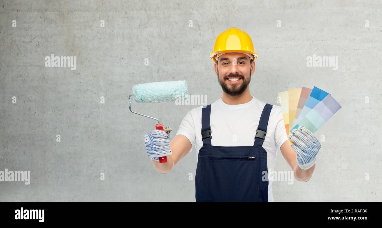 male builder with paint roller and color palettes Stock Photo Alamy