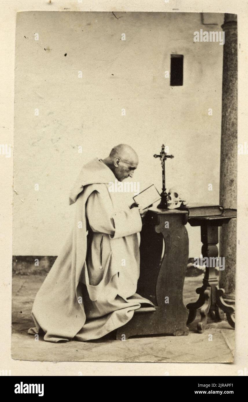 A friar praying at the Carthusian Monastery of Certosa di Pavia, Italy, circa 1865. Photography by Francis Heyland (1830 - 1908). Stock Photo