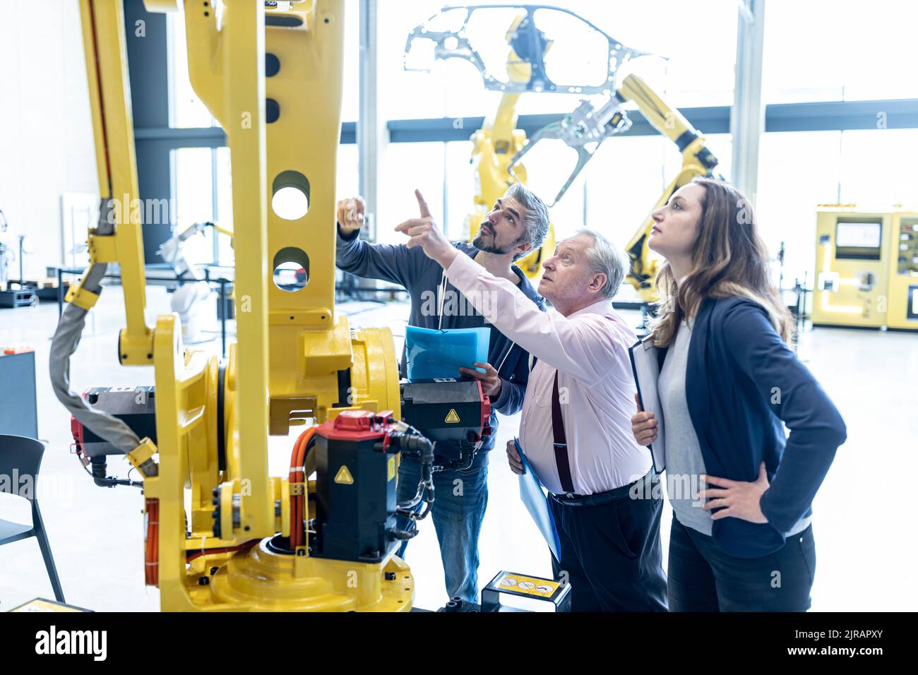 Technicians examining industrial robot in factory Stock Photo Alamy