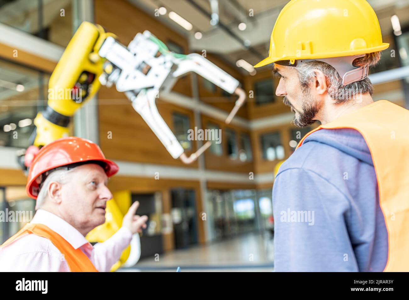 Senior colleague in work wear having meeting with skilled worker Stock Photo