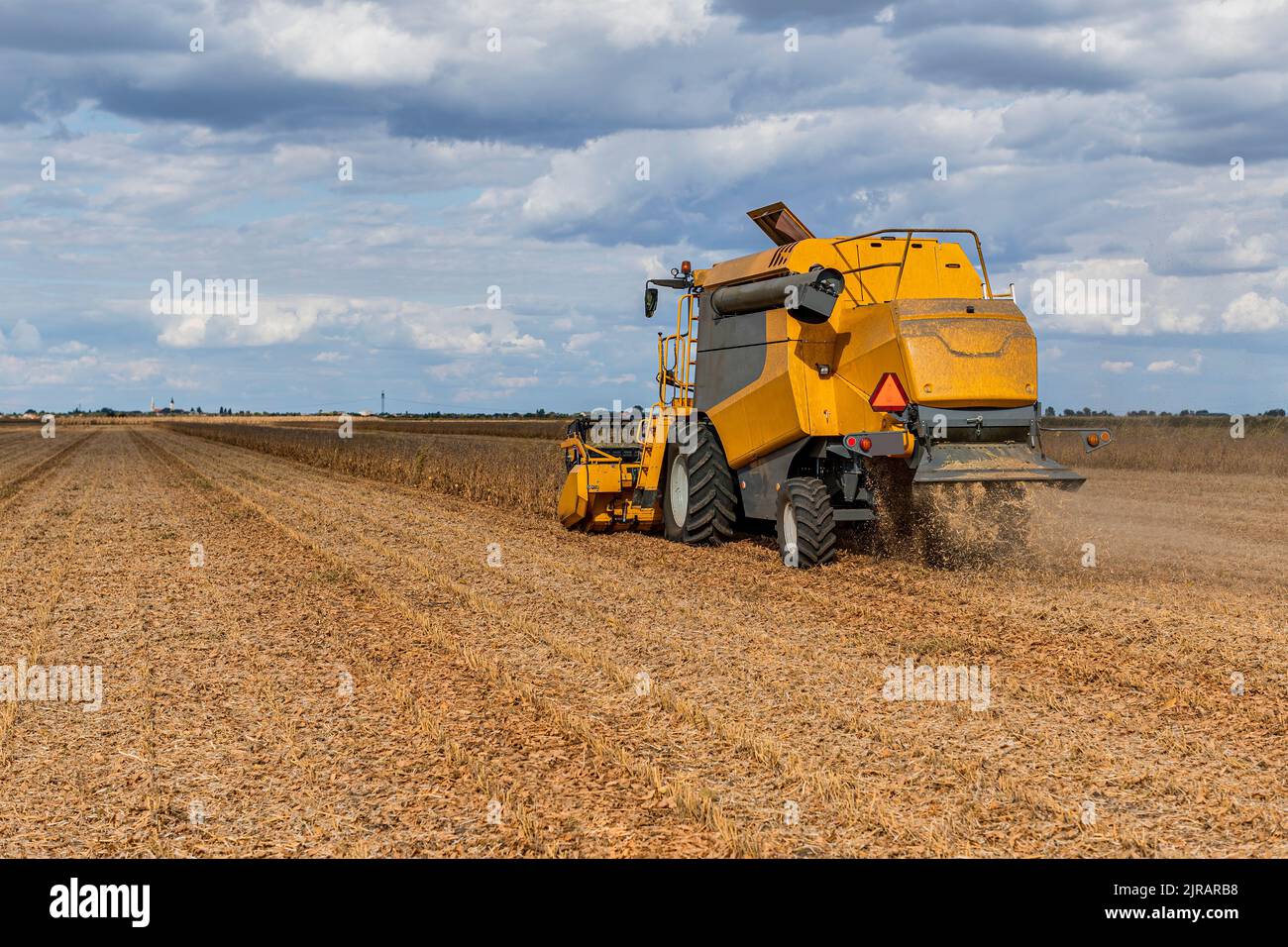 Machinery harvesting soybean on field Stock Photo