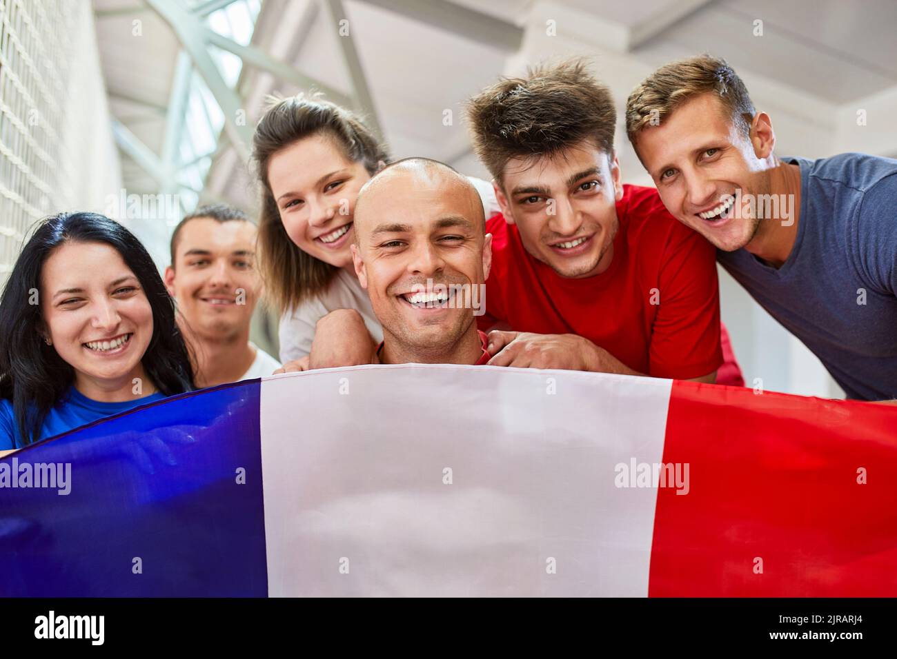 Happy sports fans with French Flag in stadium Stock Photo Alamy
