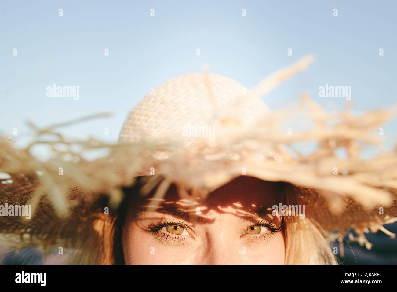 Woman wearing straw hat on sunny day Stock Photo - Alamy