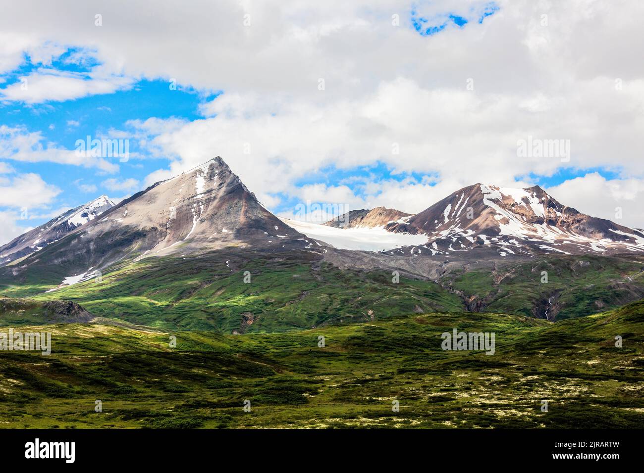 A terrific landscape in Alaska with high, snow-covered mountains, and ...