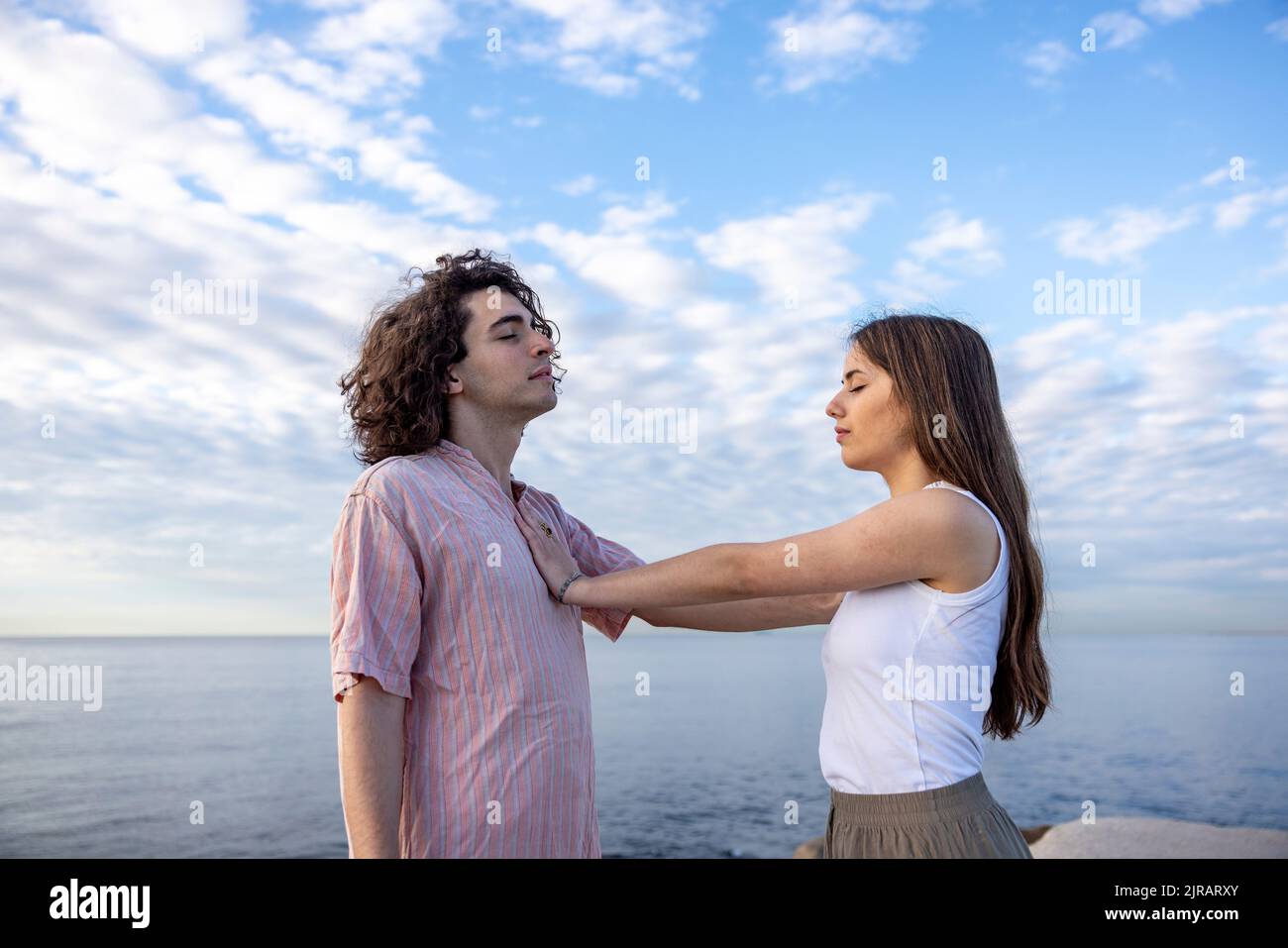 Premium Photo  Photo of happy couple looking at each other girl holding  hand on bare chest of guy