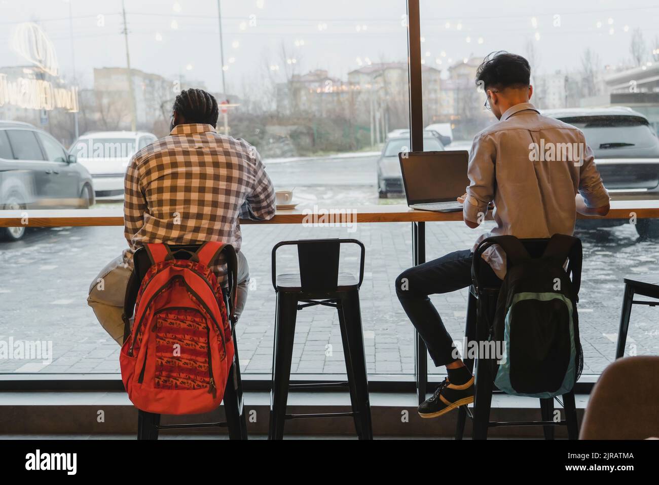 Young freelancers working at table in cafe Stock Photo