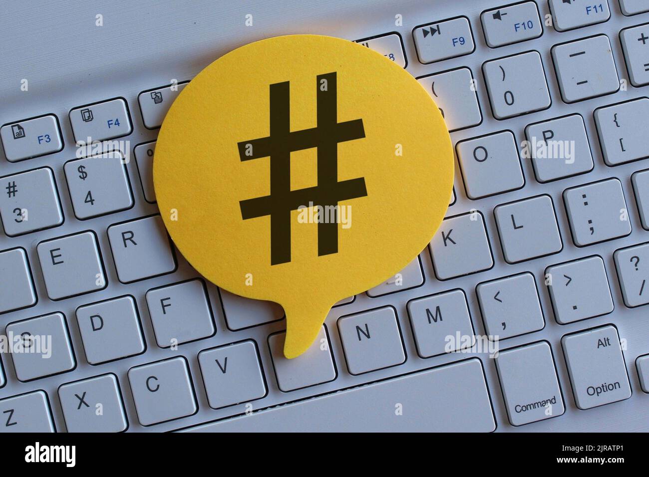 Top view image of computer keyboard and speech bubble with hashtag icon. Stock Photo