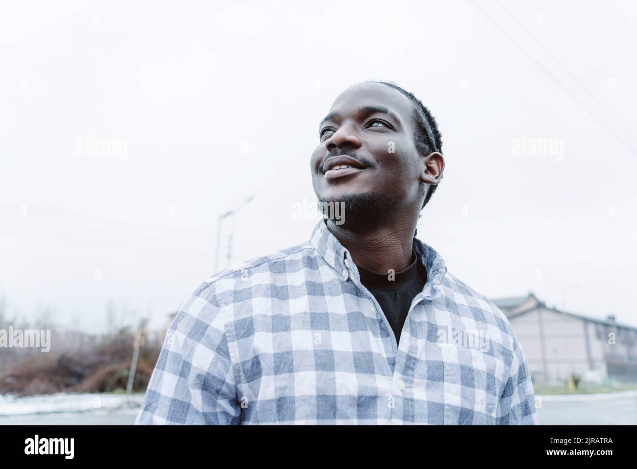 Happy young man looking up at sky Stock Photo