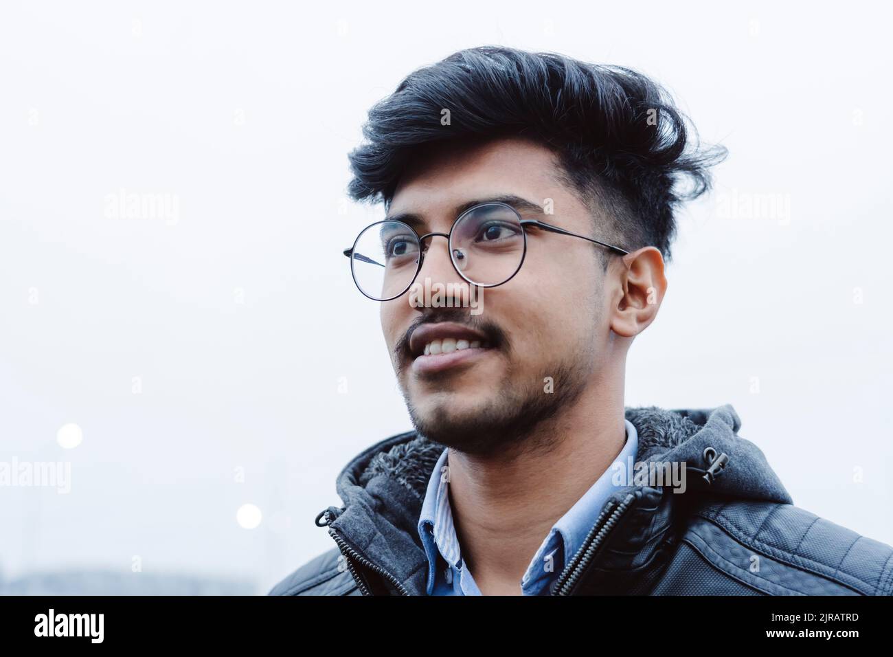 Smiling young man wearing eyeglasses Stock Photo