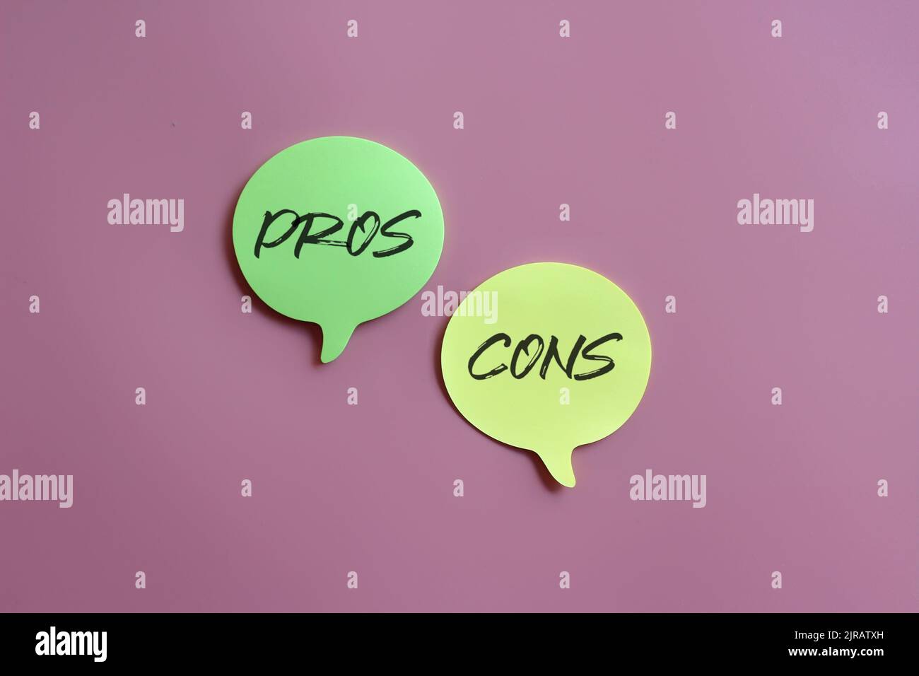 Pros and Cons concept. Speech bubble with text PROS and CONS on pink background Stock Photo