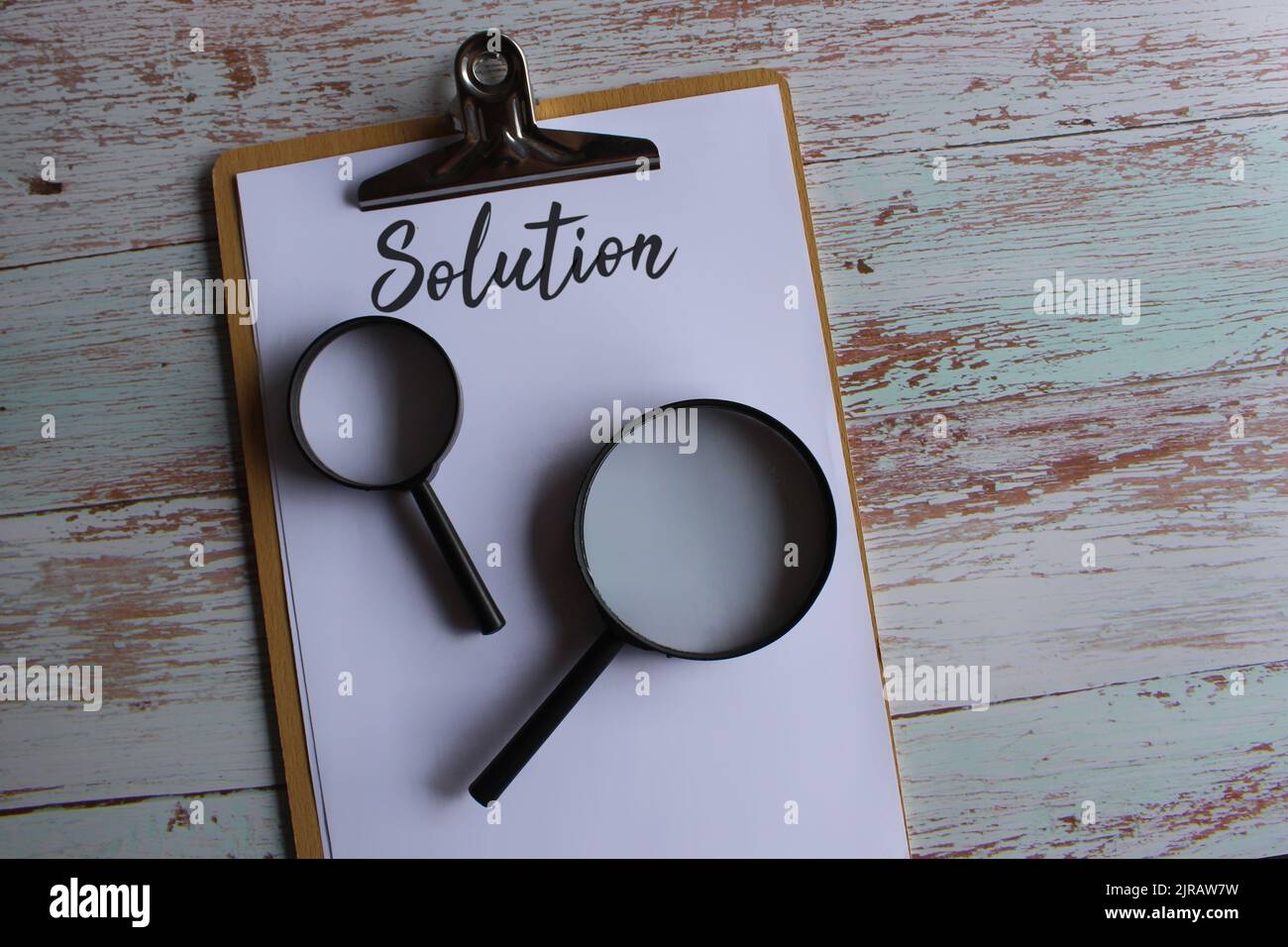 Searching for solution, finding solution concept. Magnifying glass and text SOLUTION. Stock Photo