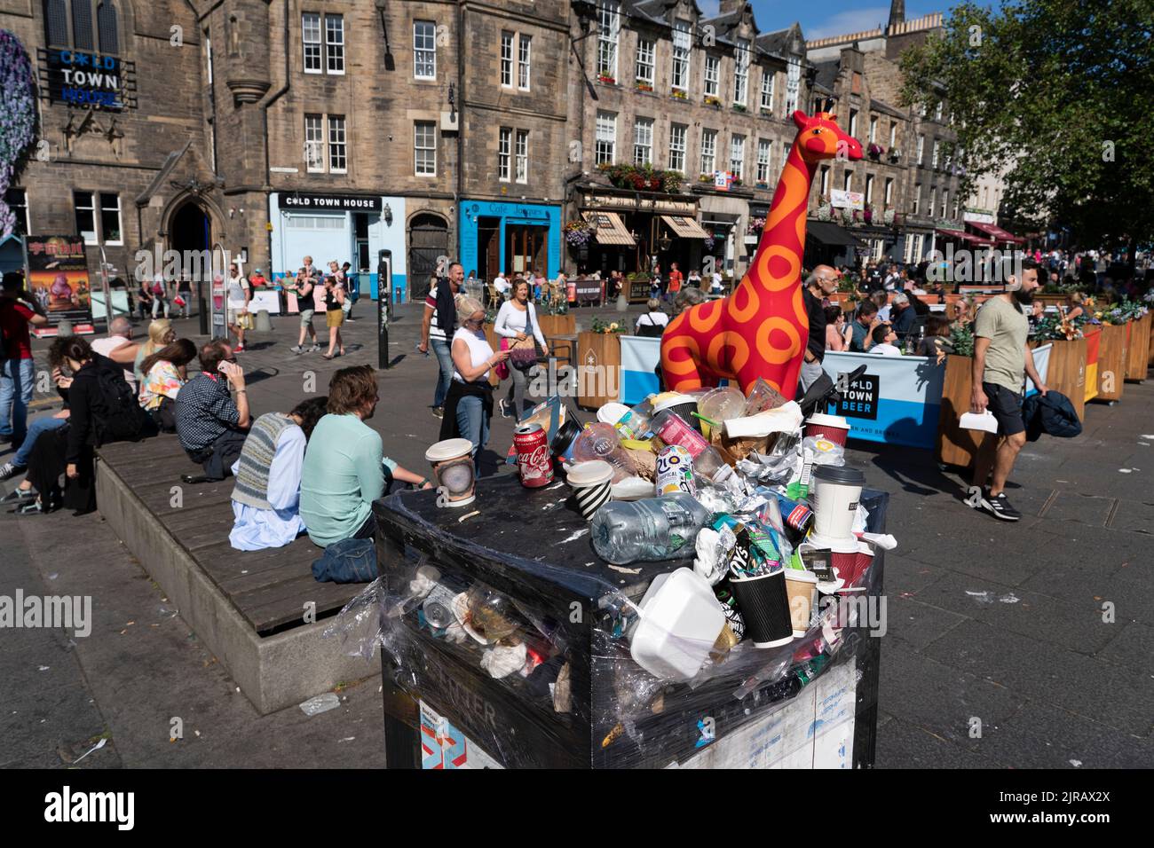 Edinburgh, Scotland, UK. 23rd  August 2022. Rubbish is seen piled on the streets of Edinburgh city centre on day six of a 12 day strike by city refuse collectors. Pic; Overflowing rubbish bin next to outdoor eating areas in the Grassmarket. Iain Masterton/Alamy Live News Stock Photo
